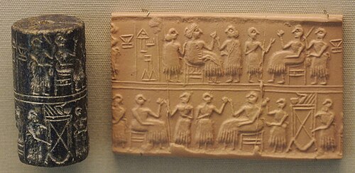 Dark stone cylinder seal next to its rolled-out clay impression showing seated figures at a banquet
